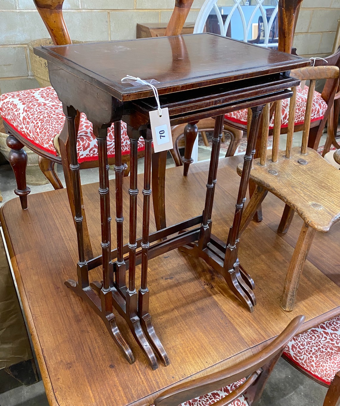 A nest of three rectangular Edwardian mahogany tea tables, width 50cm, depth 35cm, height 71cm